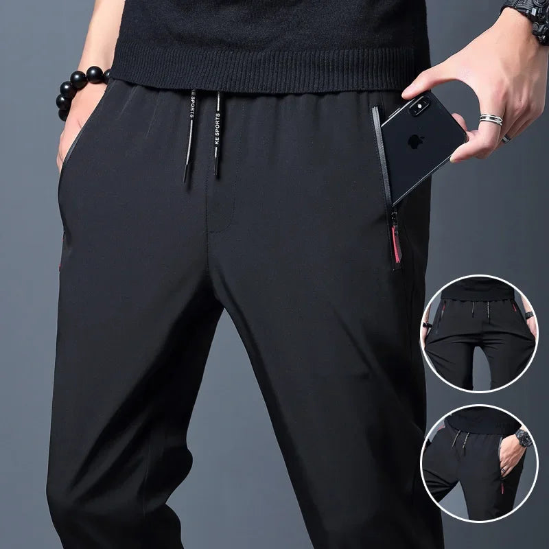 Calças casuais masculinas elásticas slim fit, calças de corrida com cintura elástica, estilo coreano, azul, preto, cinza, calças masculinas de marca plus size