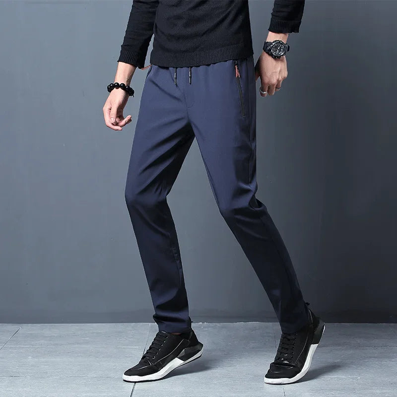 Calças casuais masculinas elásticas slim fit, calças de corrida com cintura elástica, estilo coreano, azul, preto, cinza, calças masculinas de marca plus size