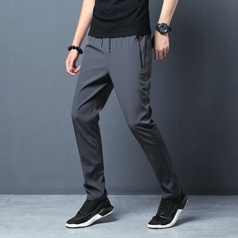Calças casuais masculinas elásticas slim fit, calças de corrida com cintura elástica, estilo coreano, azul, preto, cinza, calças masculinas de marca plus size