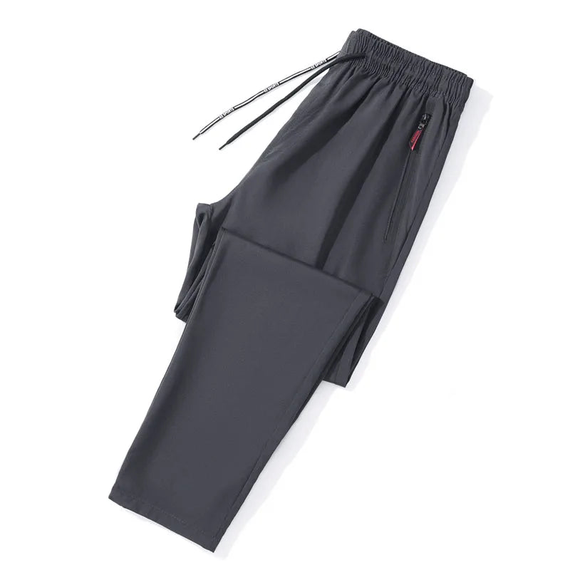 Calças casuais masculinas elásticas slim fit, calças de corrida com cintura elástica, estilo coreano, azul, preto, cinza, calças masculinas de marca plus size